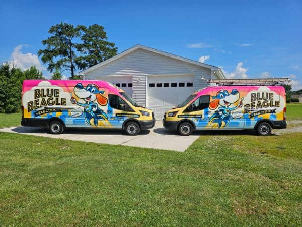 Two Blue Beagle Electric vans on a sunny day